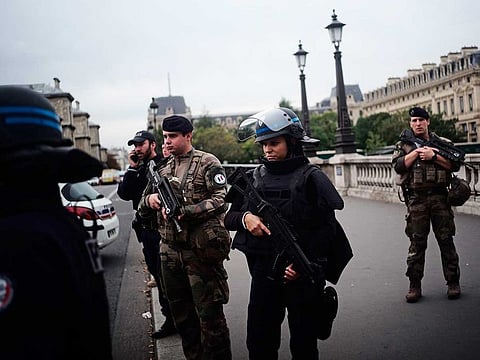 Armed police officers and soldiers patrol after an incident at the police headquarters in Paris, Thursday, Oct. 3, 2019. 
