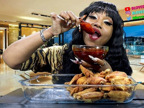This image from video released by Nate Gaskin shows Bethany Gaskin, 44, who has 2.2 million subscribers to her Bloveslife channel on YouTube. Gaskin makes more than $1 million in ad money as she eats her way through seafood boils, ginormous servings of barbecue ribs and a range of other drool-worthy spreads.  