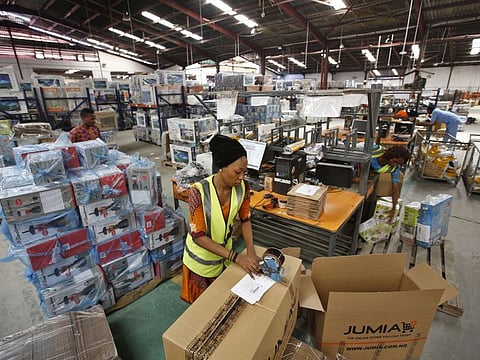Bloomberg 

A worker packages goods inside branded cardboard boxes inside a Jumia distribution warehouse in Lagos.