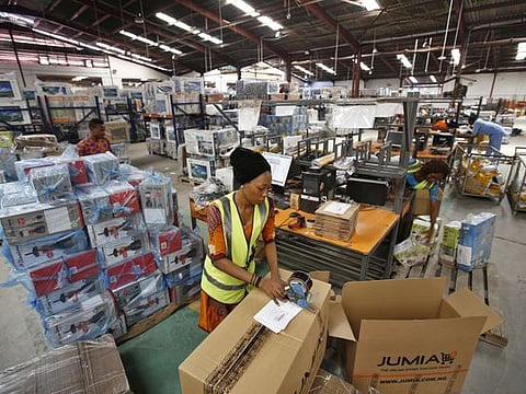 Bloomberg 

A worker packages goods inside branded cardboard boxes inside a Jumia distribution warehouse in Lagos.
