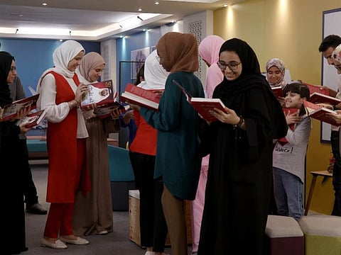 Some of the 16 contestants after receiving signed copies of the book My Story, which traces Shaikh Mohammad Bin Rashid’s journey of 50 years in public service.