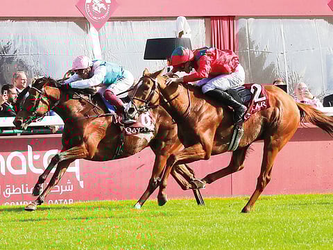 France's Pierre-Charles Boudot, right, riding Waldgeist gains on Italian jockey Frankie Dettori one Enable during the Prix de l'Arc de Triomphe at Longchamp.