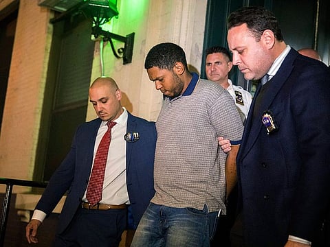 Police officers escort Randy Rodriguez Santos from the 5th Precinct to a vehicle bound for a hospital for evidence collection, Saturday, Oct. 5, 2019, in New York.