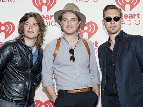 FILE - In this Sept. 21, 2013 file photo, from left, Zac, Taylor, and Isaac Hanson, arrive at the iHeartRadio Music Festival at the MGM Grand Garden Arena in Las Vegas.  Zac Hanson  is recovering following a motorcycle crash in Tulsa, Okla. this week of Oct. 5, 2019. The 33-year-old Hanson said in posts on Twitter, Facebook and the band’s website that he is recovering after suffering a broken collarbone, three broken ribs, and a cracked scapula.
Hanson said he was able to walk away from the crash thanks to “good quality protective gear.”  (Photo by Eric Jamison/Invision/AP Images)