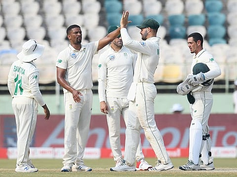 South African cricketer Vernon Philander (2L) celebrates with teammates after the dismissal of India's Cheteshwar Pujara during the fourth day's play of the first Test match at the Dr. Y.S. Rajasekhara Reddy ACA-VDCA Cricket Stadium in Visakhapatnam on October 5, 2019. 