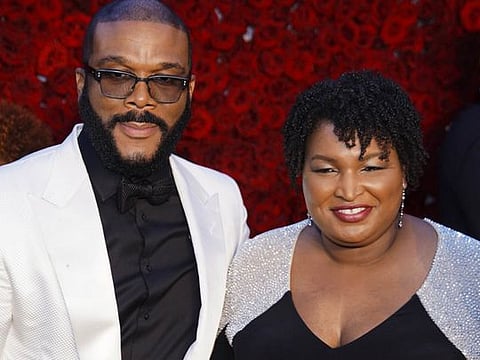 Tyler Perry and Stacey Abrams pose for a photo on the red carpet at the grand opening of Tyler Perry Studios on Saturday, October 5, 2019, in Atlanta, Georgia. (Photo by Elijah Nouvelage/Invision/AP)