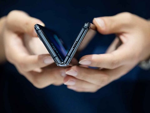 A customer tries out a Samsung Galaxy Fold smartphone at the company's D'light flagship store in Seoul, South Korea.