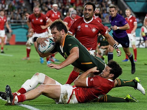 South Africa's centre Frans Steyn dives a scores a try past Canada's centre Ciaran Hearn.