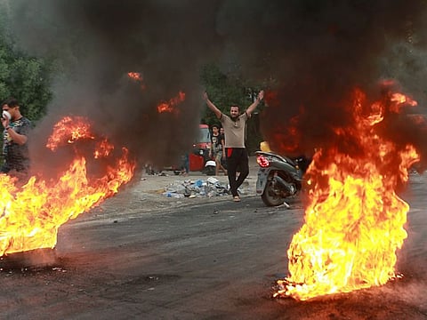Anti-government protesters set fires during a demonstration in Baghdad, Iraq, on October 6, 2019. 