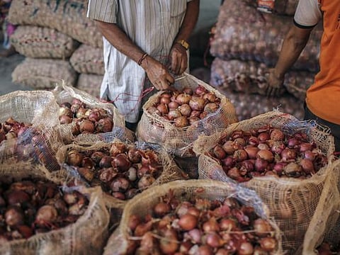 Bloomberg 
A worker seals a sack of onions at a wholesale market in Mumbai on October 3.