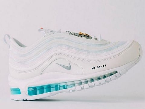 The distinctive pair of white Nike Air Max 97s termed 'Jesus Shoes' are manufactured by a Brooklyn-based creative label MSCHF.