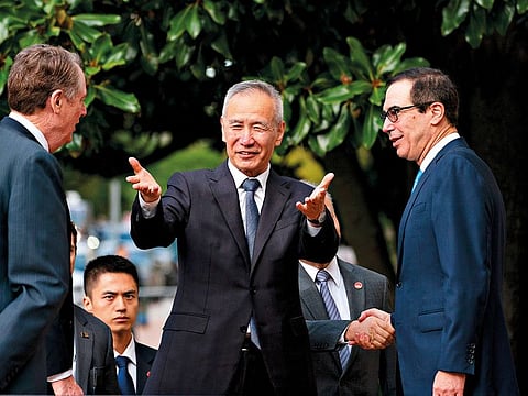 Liu He, China's vice premier, centre, gestures while arriving for a meeting with Steven Mnuchin, US Treasury secretary, right, and Robert Lighthizer, US trade representative, second left, at the Office of the US Trade Representative in Washington, D.C., on Thursday, October 10, 2019. 