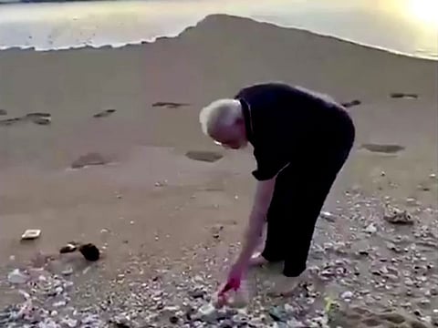 India's Prime Minister Narendra Modi picks up plastic trash at the beach ahead of talks with China's President President Xi Jinping in Mamallapuram, India October 12, 2019 in this still image obtained from video. 