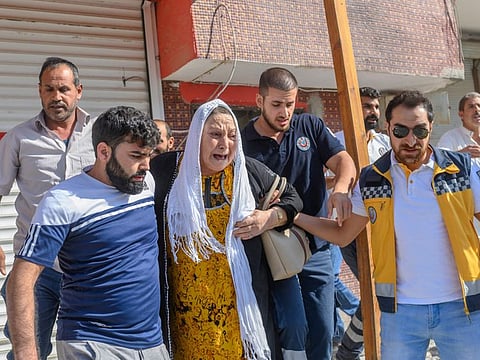 An elderly woman is evacuated from a building in Akcakale, a town near the Turkish border with Syria on October 13, 2019, after it was hit by a rocket reported to be fired from within Syria.  