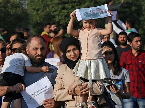 A Kurdish family takes part in a demonstration in Arbil, the capital of the northern Iraqi Kurdish autonomous region, on October 10, 2019 against the Turkish offensive in northeastern Syria. 
