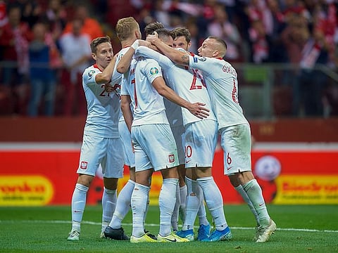 Poland forward Arkadiusz Milik (second from left) celebrates scoring to make it 2-0.