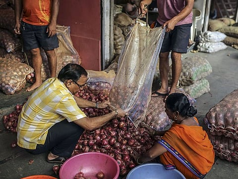 Workers sort onions on display at the Vashi Agricultural Produce Market Committee (APMC) wholesale market in Mumbai, India.