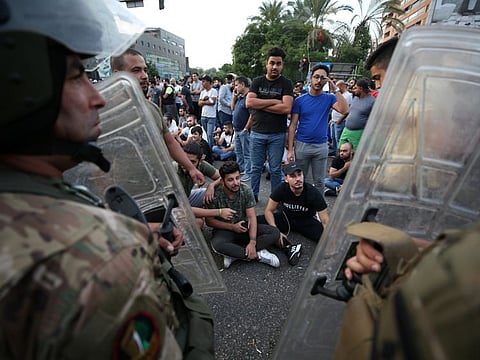Demonstrators gather during a protest over deteriorating economic situation, in the port city of Sidon, Lebanon October 18, 2019. 