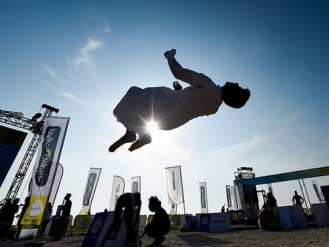 Zayed Al Nuaimi backflips at the Dubai Fitness Challenge 2019 at Kite Beach, Dubai. 18th October 2019. Photo: Ahmed Ramzan/ Gulf News