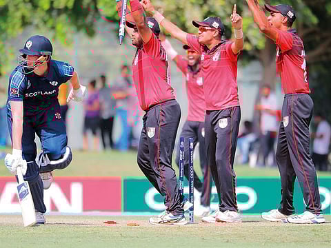Singapore celebrate as Scotland's Alasdair Evans is run out.