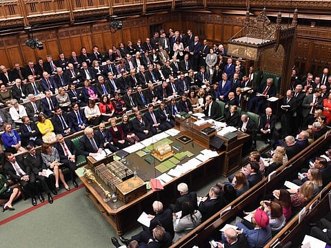 A handout picture released by the UK Parliament shows Britain's Prime Minister Boris Johnson making a statement in the House of Commons in London Saturday.