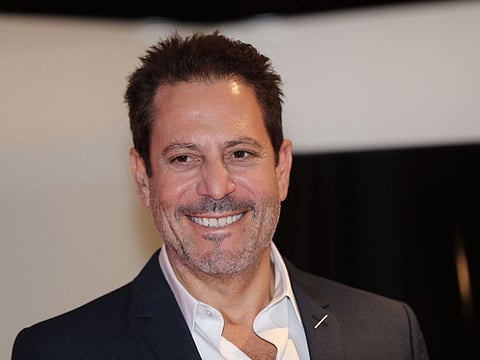 US producer, director and writor of film Darren Star poses with his 'Cannes series Award' trophy for his career in the television and cinema at the MIPCOM, the World's biggest television and entertainment market, on October 14, 2019 in Cannes, southeastern France.    / AFP / VALERY HACHE