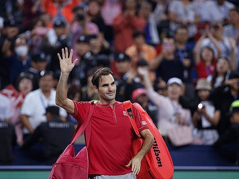 Roger Federer of Switzerland waves to spectators as he leaves the court after he lost to Alexander Zverev of Germany in their men's singles quarterfinals match at the Shanghai Masters.