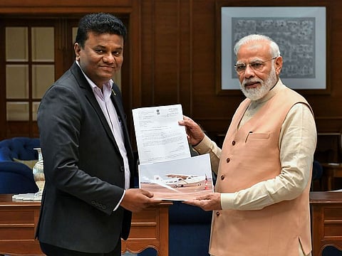 Prime Minister Narendra Modi issues a 'special' flying permit to Mumbai-based aviator Amol Yadav for his six-seater plane-all built on his terrace, in New Delhi.