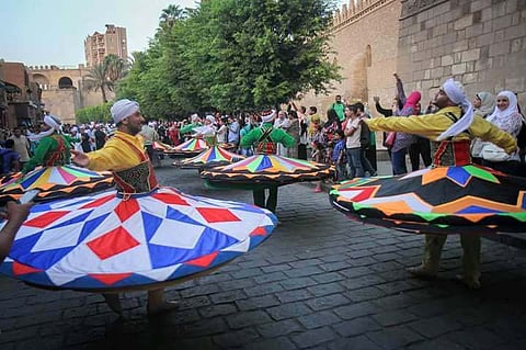 Egypt's state Tanoura Troupe of National Heritage perform in a Cairo street.