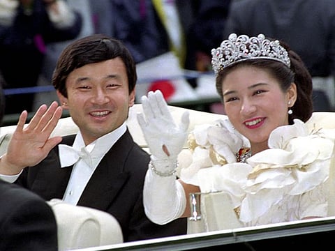 In this June 9, 1993, file photo, then Crown Prince Naruhito, left, and Crown Princess Masako wave during their wedding parade in Tokyo.