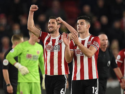 Sheffield United’s Chris Basham (L) and John Egan celebrate after the match.