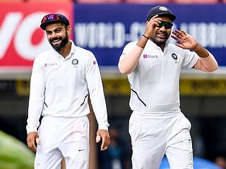 India's Virat Kohli (left) and Rohit Sharma share a moment during the third test against South Africa in Ranchi on October 21, 2019. 