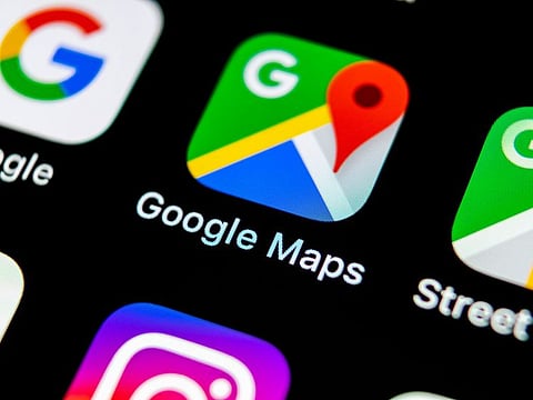 Google Maps application icon on Apple iPhone X screen.