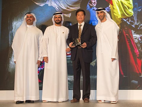 Jubo Cao receive an award by on the right Dr. Thani bin Ahmed Al Zeyoudi, Minister of Climate Change and Environment and Chairman of the Global Council on Sustainable Development Goal during the UAE SDG Photography Award taking place at the Dubai Frame. Dubai. Photo: Antonin Kélian Kallouche/Gulf News