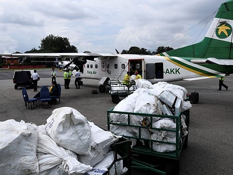 (FILES) In this file photo taken on September 4, 2019, Nepali airline staff unload waste collected from the Everest region brought to the capital for recycling, at Tribhuvan airport in Kathmandu. In homes across the Nepali capital too upcycled items -- from pots to lamps -- crafted from Everest waste products are slowly making their way, as authorities and businesses look for fresh ways to tackle the damage caused by decades of commercial mountaineering.  - To go with 'NEPAL-EVEREST-MOUNTAINEERING-ENVIRONMENT-CLEANUP,FEATURE by Paavan MATHEMA
 / AFP / PRAKASH MATHEMA / To go with 'NEPAL-EVEREST-MOUNTAINEERING-ENVIRONMENT-CLEANUP,FEATURE by Paavan MATHEMA