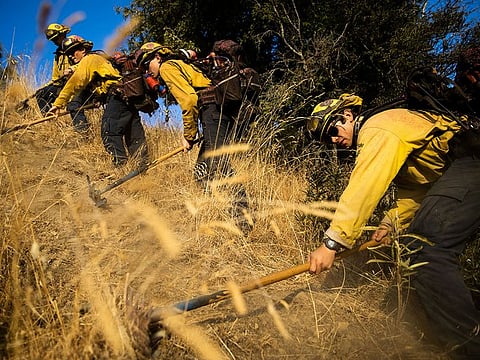 Firefighters with the Marin County Fire Department begin to dig a containment line ahead of the Kincade Fire, in the Geysers, a geothermal field in California on Friday, Oct. 25, 2019.
