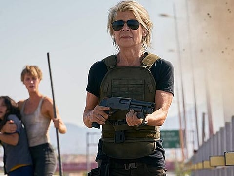 Linda Hamilton in "Terminator: Dark Fate." In the background are Natalia Reyes and Mackenzie Davis. (Paramount Pictures)