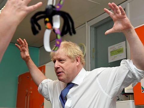 Britain's Prime Minister Boris Johnson reacts while he speaks to chief nurse Nicola Burns-Muir at the children's ward as he visits Milton Keynes University Hospital in Buckinghamshire, Britain October 25, 2019.