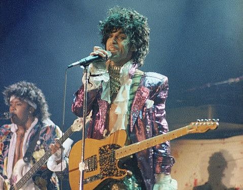 FILE - In this 1985 file photo, singer Prince performs in concert. The Revolution, the band that helped catapult Prince to international superstardom is reuniting in his memory. The Revolution, which backed up Prince in the 1980s, will play two shows Sept. 2-3, 2016, at First Avenue, the downtown Minneapolis nightclub where Prince and the Revolution filmed “Purple Rain.” (AP Photo/File)