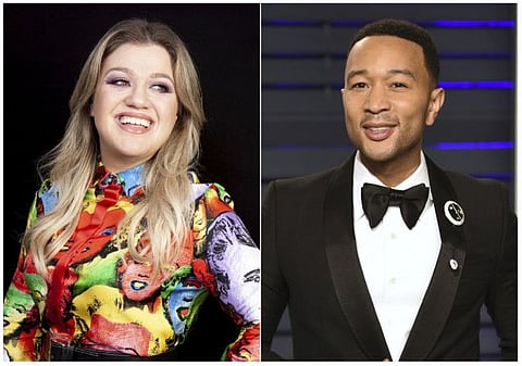 This combination photo shows singer and talk show host Kelly Clarkson during a portrait session in Los Angeles to promote her animated film "Uglydolls" in April 14, 2019, left, and singer John Legend at the Vanity Fair Oscar Party in Beverly Hills, Calif. on Feb. 24, 2019. Clarkson and Legend have joined forces on a reimagined version of the oft-criticized Christmas classic “Baby It’s Cold Outside.” (AP Photo)