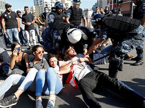 Anti-government protestors react as police try to open a blocked highway in Beirut, Lebanon October 31, 2019. 