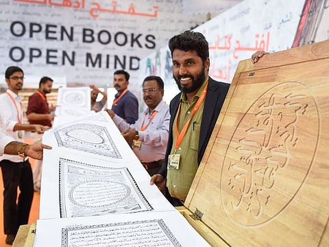 M Dileep(right), caricaturist, attempted World Longest Quran displayed at 38th edition of the Sharjah International Book Fair (SIBF) at the Sharjah Expo Centre on Wednesday. 30th October 2019, Photo: Ahmed Ramzan/ Gulf News