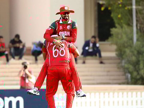 Oman celebrate a wicket against Scotland. 