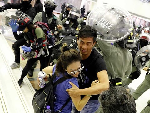 People scuffle with riot police at a shopping mall in Tai Po in Hong Kong on November 3.