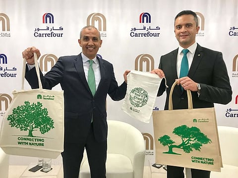 Ibrahim Al Zu’bi and Hani Weiss display a range of reusable bags that will be used instead of plastic bags at Carrefour after the press conference in Dubai on Tuesday . 
PHOTO Sajila Saseendran