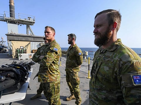 Australian divers stand aboard Britain's RFA Cardigan Bay landing ship in the Gulf waters off Bahrain during the International Maritime Exercise (IMX), on November 5, 2019.