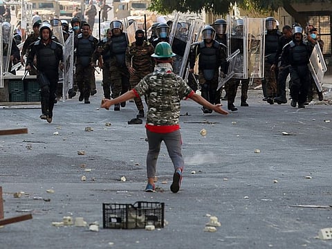 Iraqi anti-riot police try to prevent anti-government protesters from crossing the al- Shuhada (Martyrs) bridge in central Baghdad, Iraq, Wednesday, Nov. 6, 2019. 
