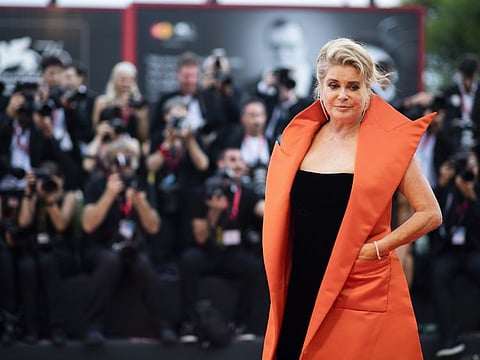 FILE - In this Aug. 28, 2019 file photo, French actress Catherine Deneuve poses for photographers upon arrival at the premiere of the film 'The Truth' and the opening gala at the 76th edition of the Venice Film Festival, Venice, Italy. Denueve's family said in a statement released Wednesday Nov. 6, 2019, that the 76-year-old actress suffered a "very limited and therefore reversible" stroke. (Photo by Arthur Mola/Invision/AP, File)