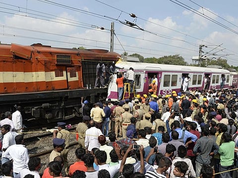 Emergency personnel work to rescue a worker in the cabin of a surburban rail train after it collided with an intercity express train at Kachiguda Railway Station in Hyderabad