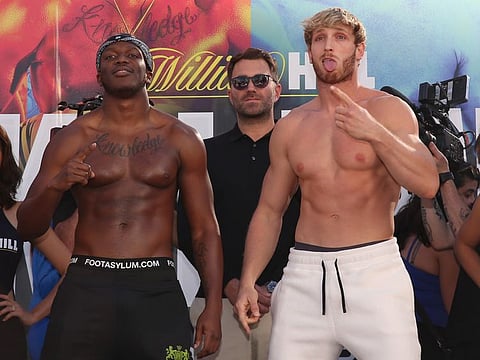 LOS ANGELES, CALIFORNIA - NOVEMBER 08: Logan Paul (R) mocks and imitates KSI while promoter Eddie Hearn looks on after the official weigh-in at L.A. Live Xbox Plaza on November 08, 2019 in Los Angeles, California.   Victor Decolongon/Getty Images/AFP
== FOR NEWSPAPERS, INTERNET, TELCOS & TELEVISION USE ONLY ==